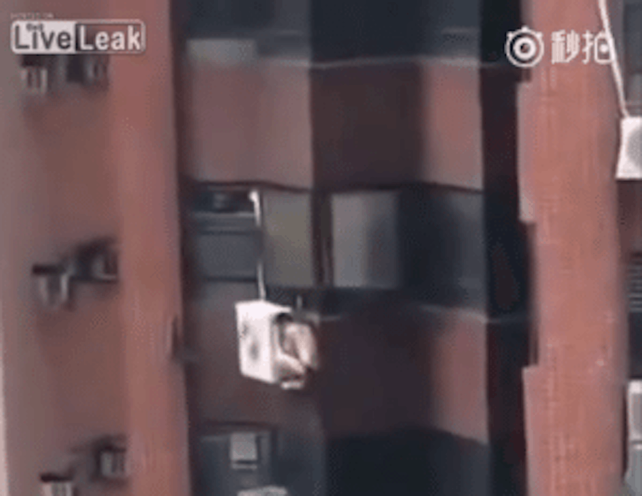 Naked Man Clings To Air Conditioner